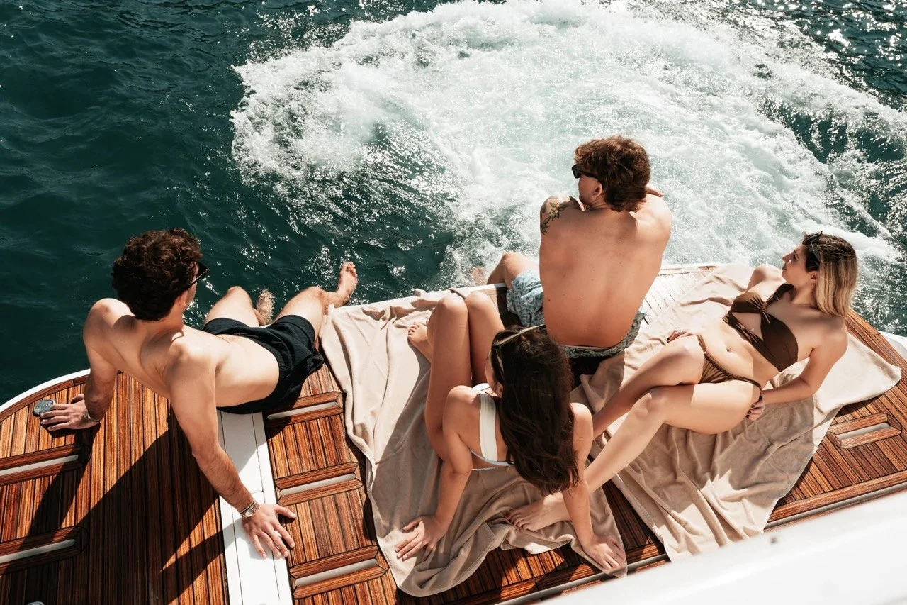 Guests relaxing together on the Azimut 53 Fly aft sunpad
